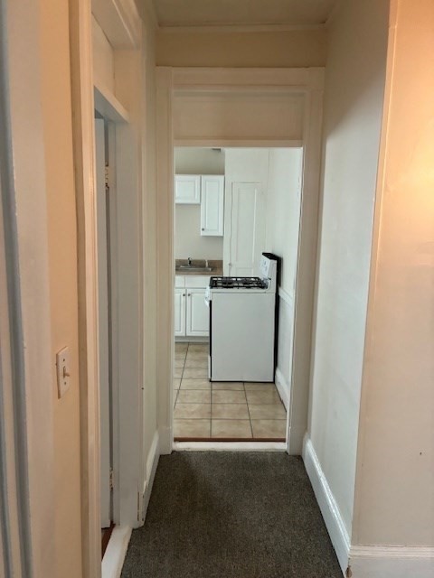 180 Lewis Street, Unit 2 Lynn, MA 01902 - Photo 5 of 14 a view of a kitchen from the hallway
