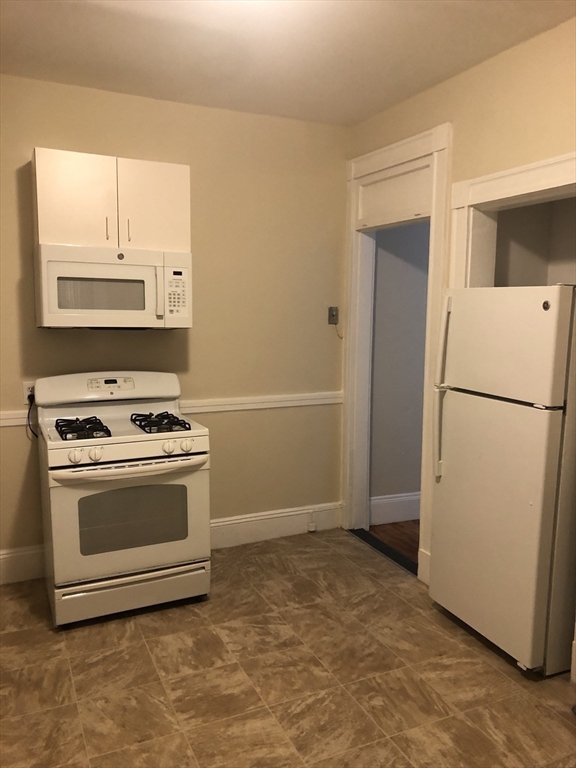 180 Lewis Street, Unit 2 Lynn, MA 01902 - Photo 8 of 14 a kitchen with a stove top oven and refrigerator