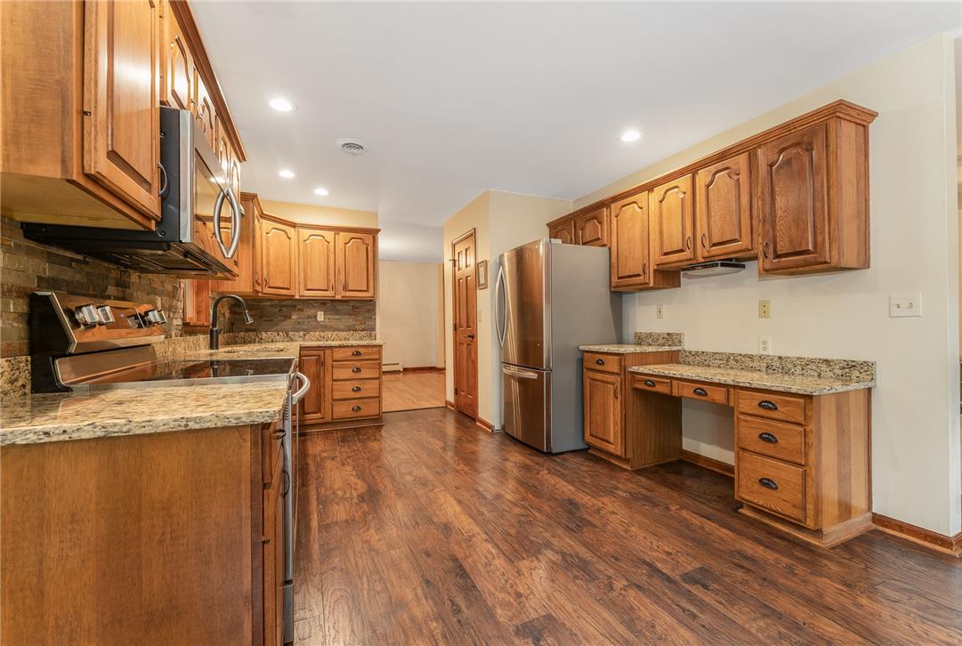465 Raubsville Road Easton, PA 18042 - Photo 19 of 60 Culinary creations come to life in this kitchen featuring abundant wood cabinetry and elegant granite counters.