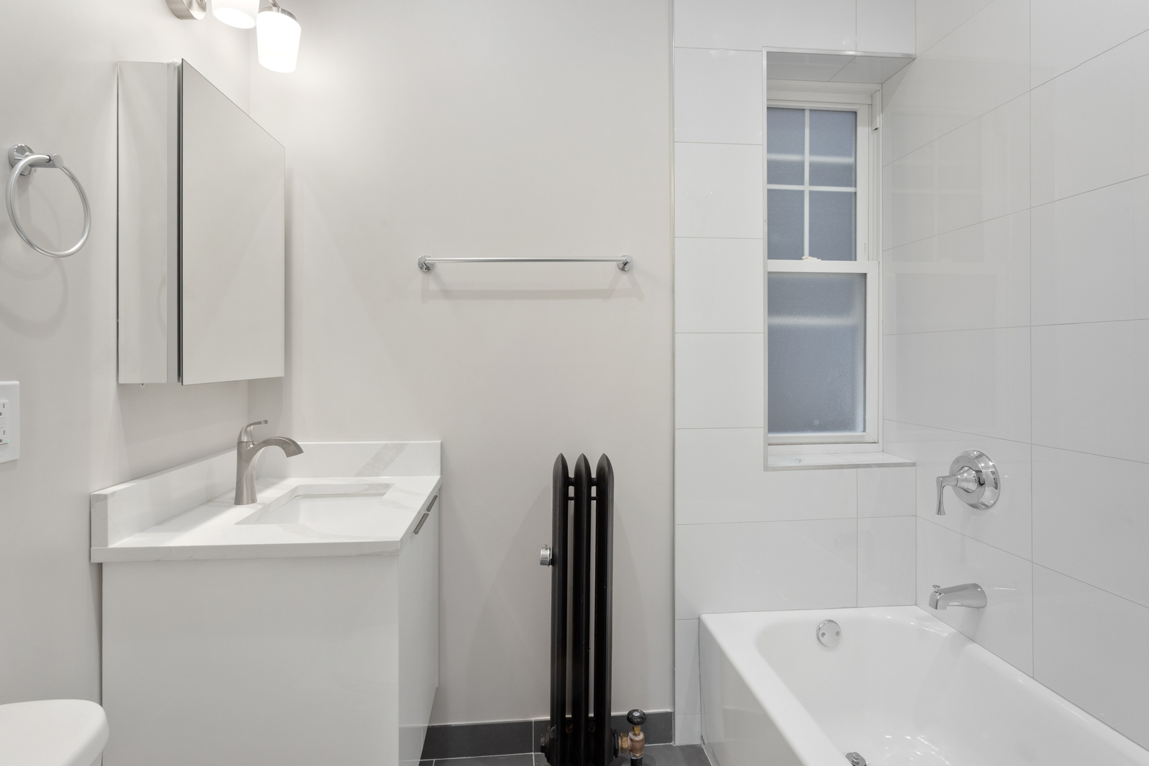 1904 West Morse Avenue, Unit 1 Chicago, IL 60626 - Photo 12 of 15 a bathroom with a sink a toilet and shower