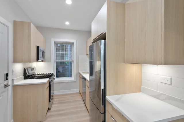 a kitchen with a refrigerator stove and sink