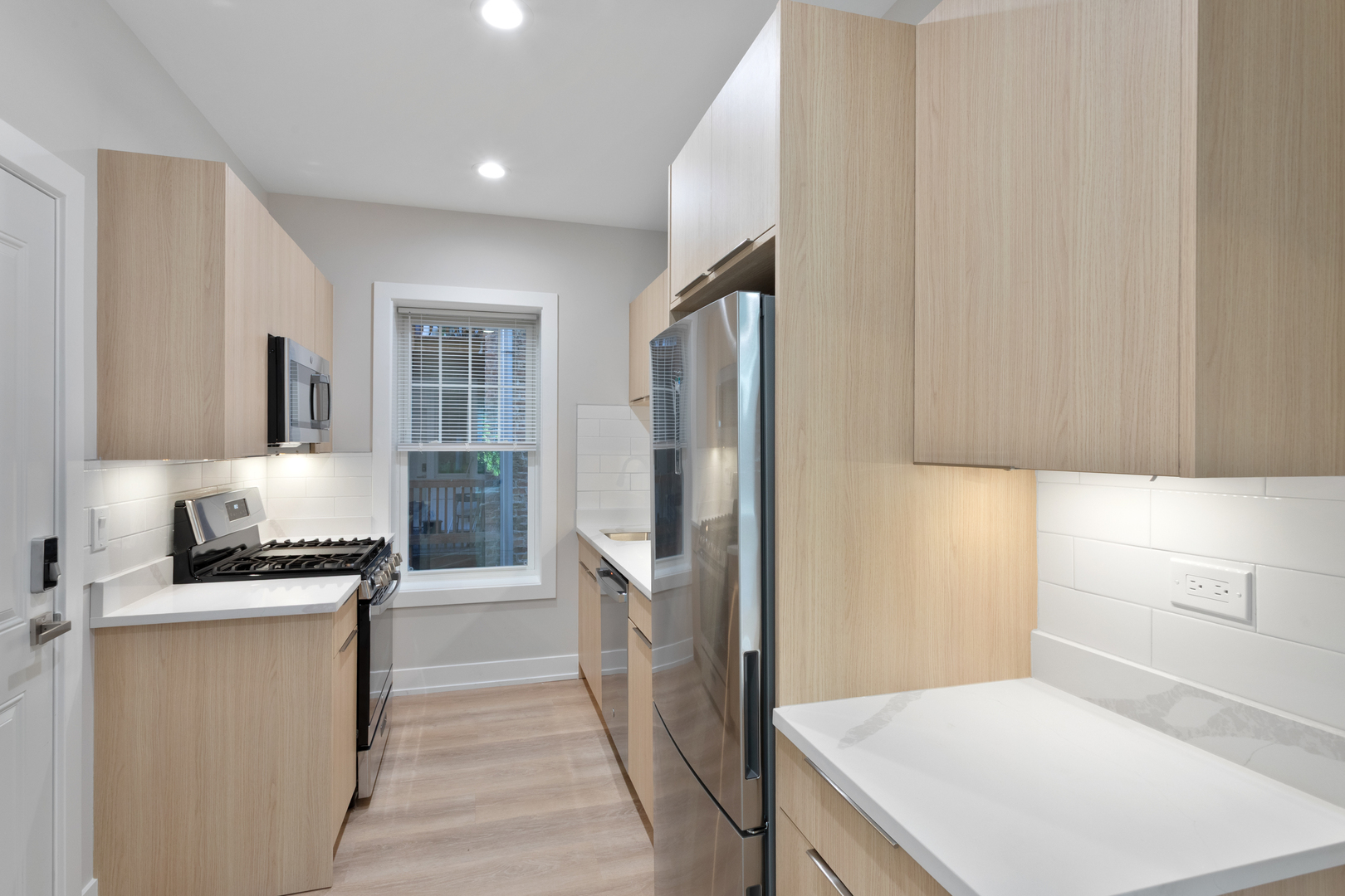 1904 West Morse Avenue, Unit 1 Chicago, IL 60626 - Photo 3 of 15 a kitchen with a refrigerator stove and sink