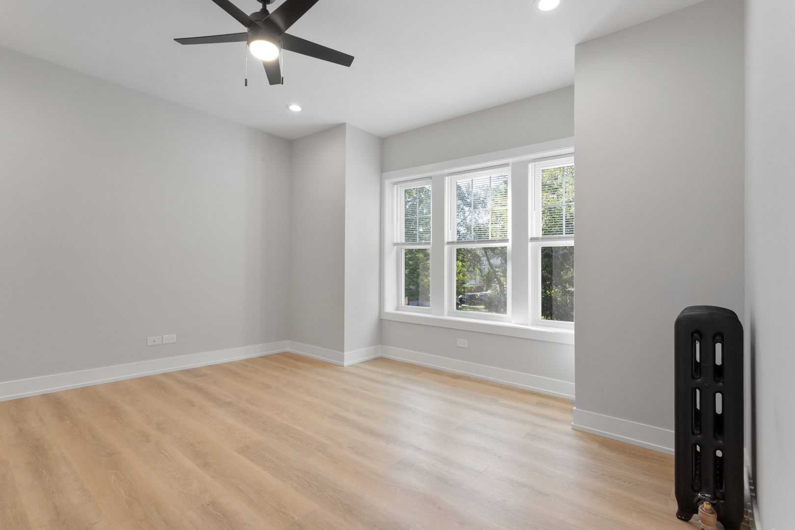 1904 West Morse Avenue, Unit 1 Chicago, IL 60626 - Photo 5 of 15 a view of an empty room with a window and wooden floor