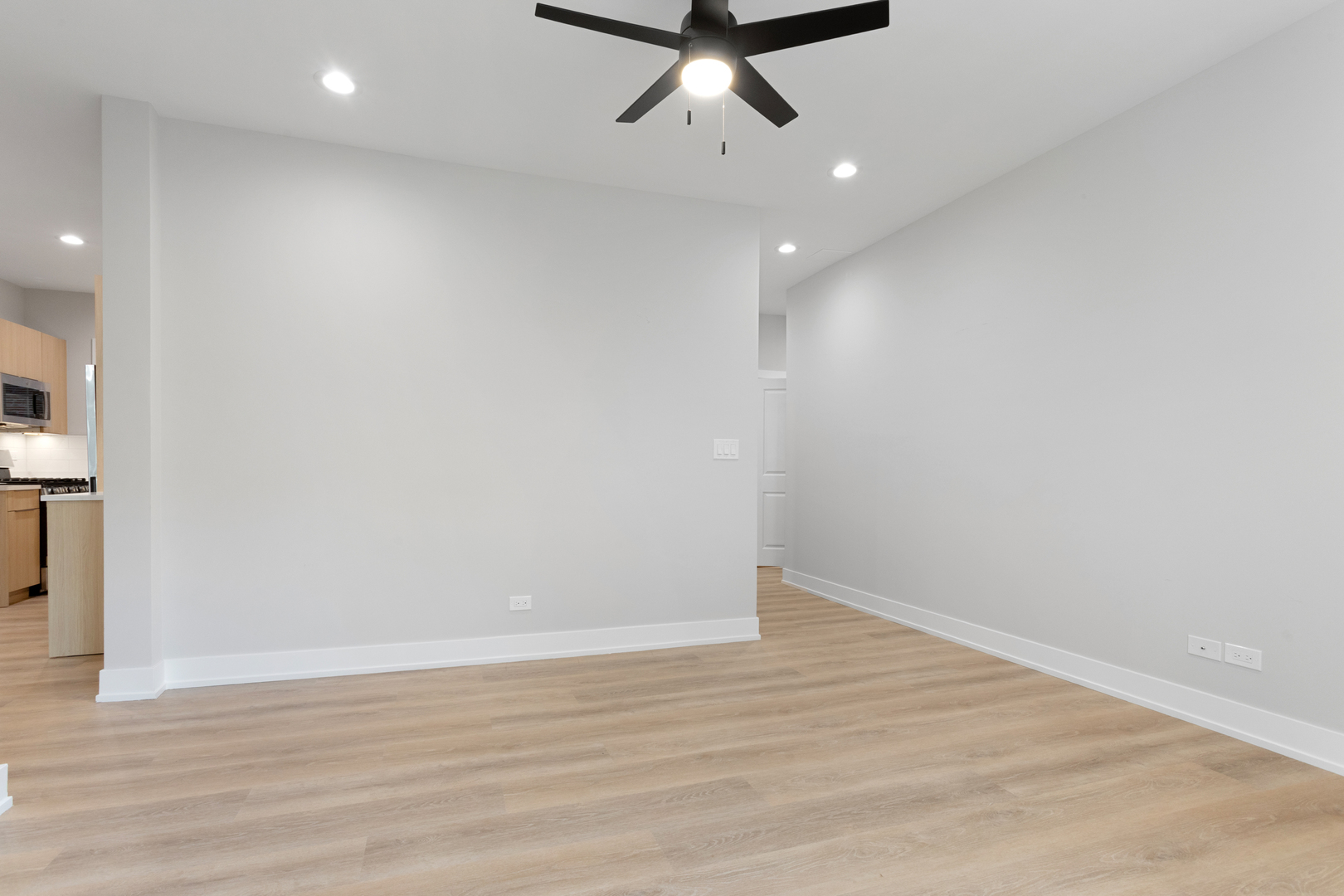 1904 West Morse Avenue, Unit 1 Chicago, IL 60626 - Photo 7 of 15 a view of a room with wooden floor and ceiling fan