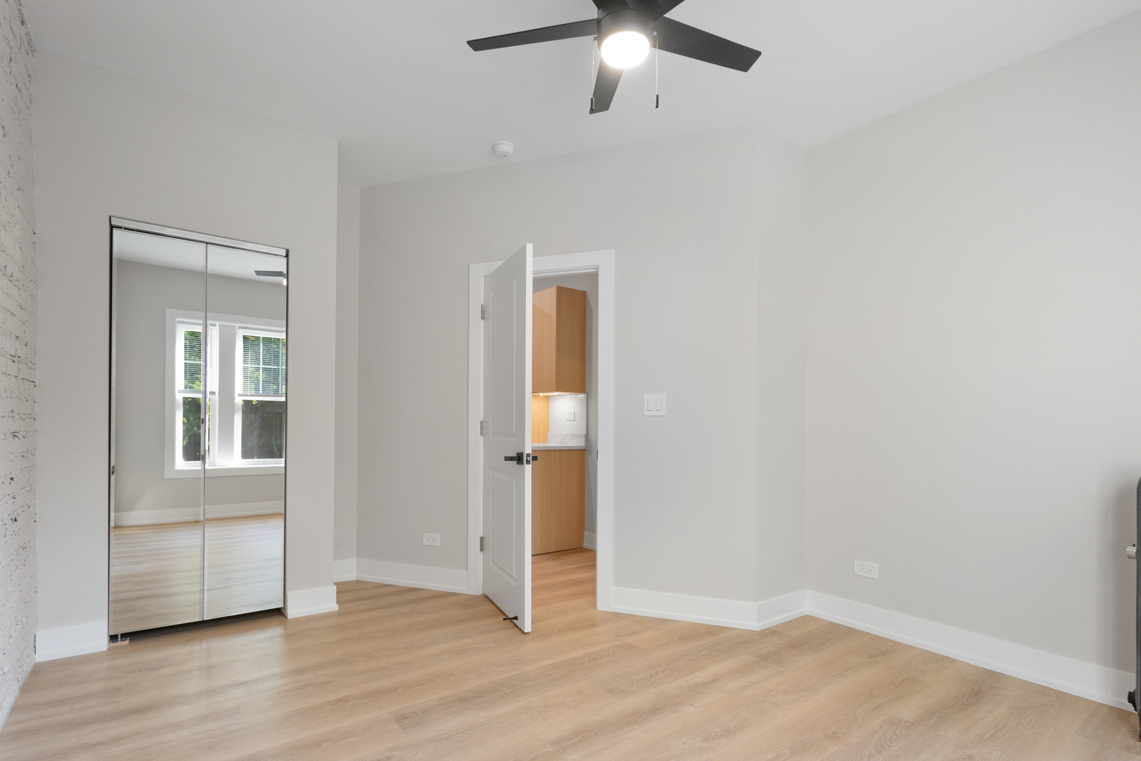 1904 West Morse Avenue, Unit 1 Chicago, IL 60626 - Photo 8 of 15 wooden floor in an empty room with a window