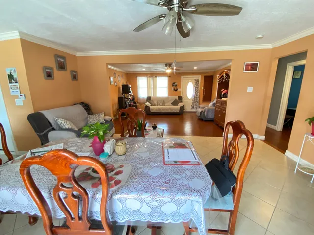 a view of a dining room with furniture and a chandelier