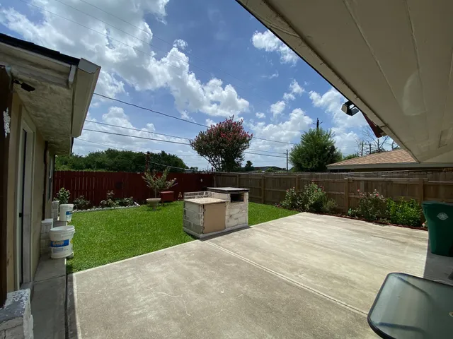 a front view of a house with garden and parking