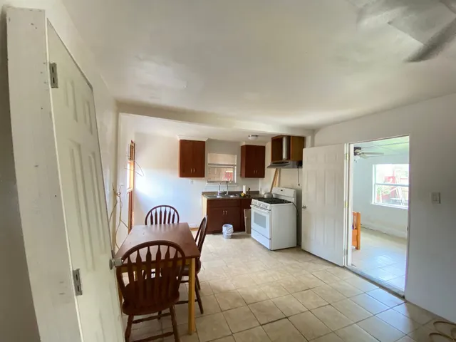 a kitchen with stainless steel appliances a stove a sink and a refrigerator