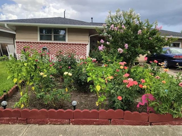 a front view of a house with a yard and fountain