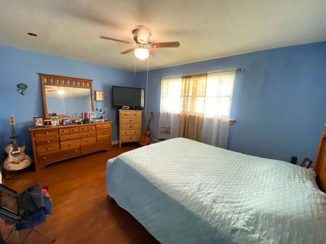 a bedroom with bed and window