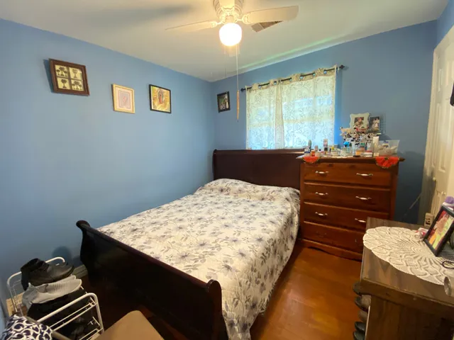 a bed sitting in a bedroom next to a window