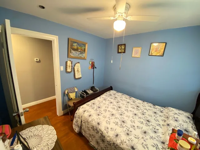 a bedroom with a bed and a dresser in it