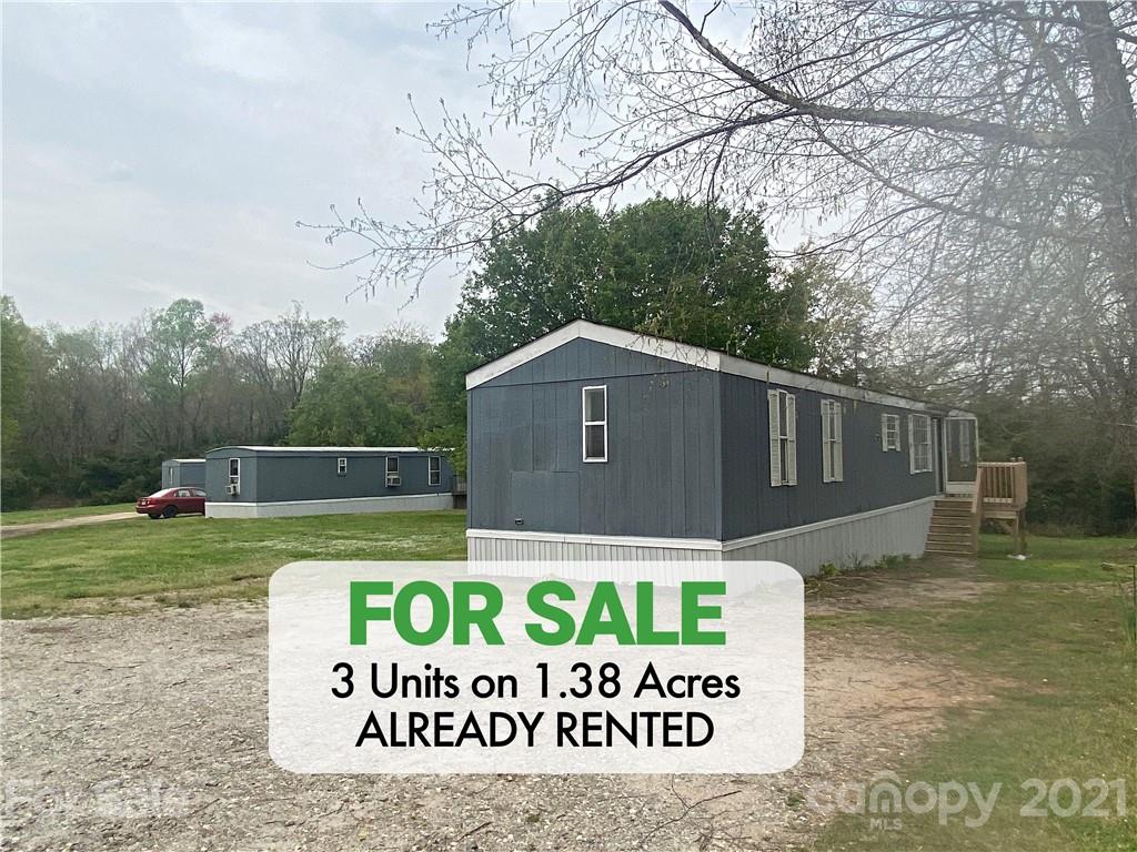 a sign that is sitting on a brick wall