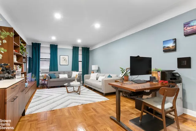 a kitchen filled with stainless steel appliances a sink a stove and white cabinets
