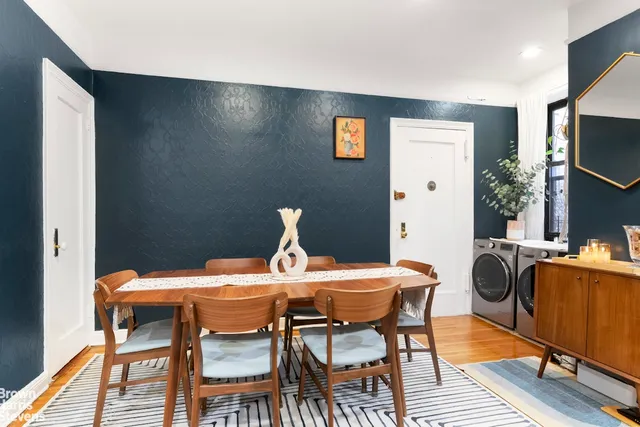 a bedroom with a large bed couch and a window