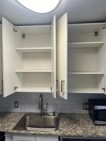 a kitchen with a sink and a counter top space