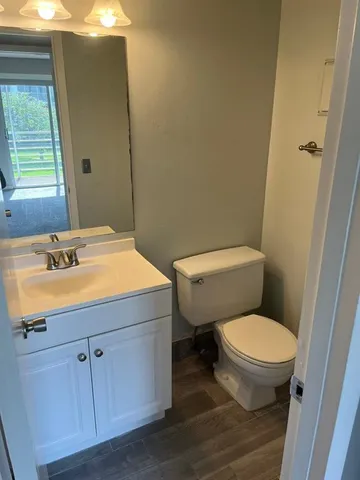 a bathroom with a sink toilet and window