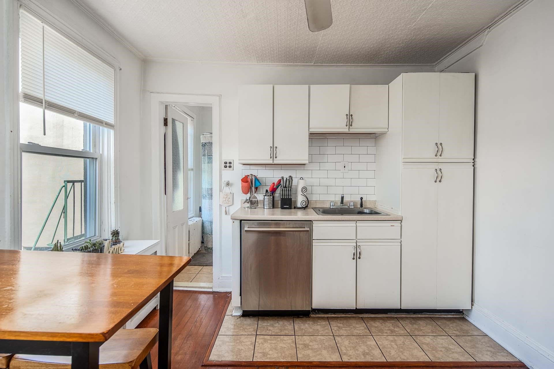 710 Bloomfield Street, Unit 3 Hoboken, NJ 07030 - Photo 3 of 13 a kitchen with stainless steel appliances granite countertop a refrigerator sink and white cabinets