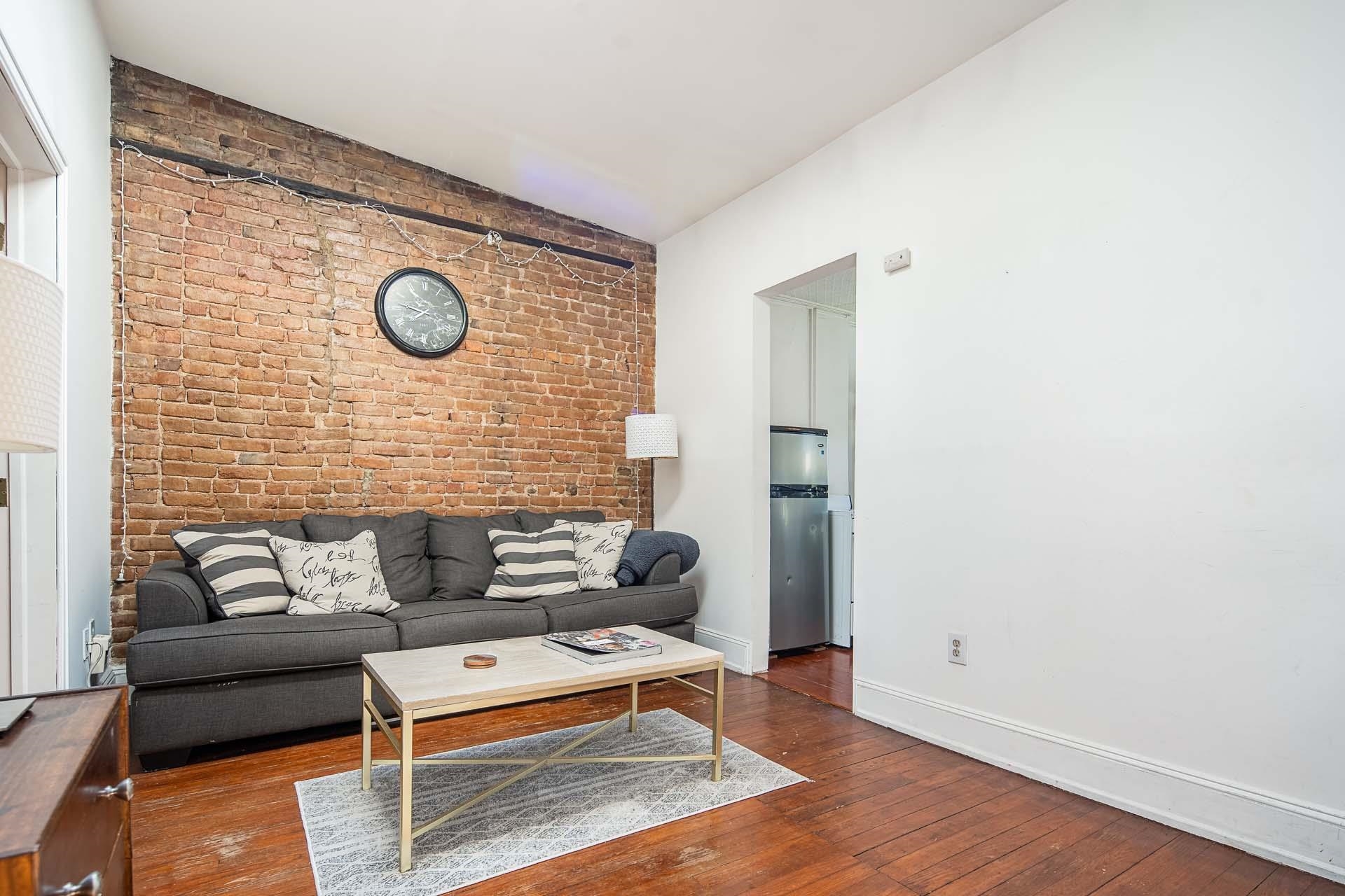710 Bloomfield Street, Unit 3 Hoboken, NJ 07030 - Photo 6 of 13 a living room with furniture and a wooden floor
