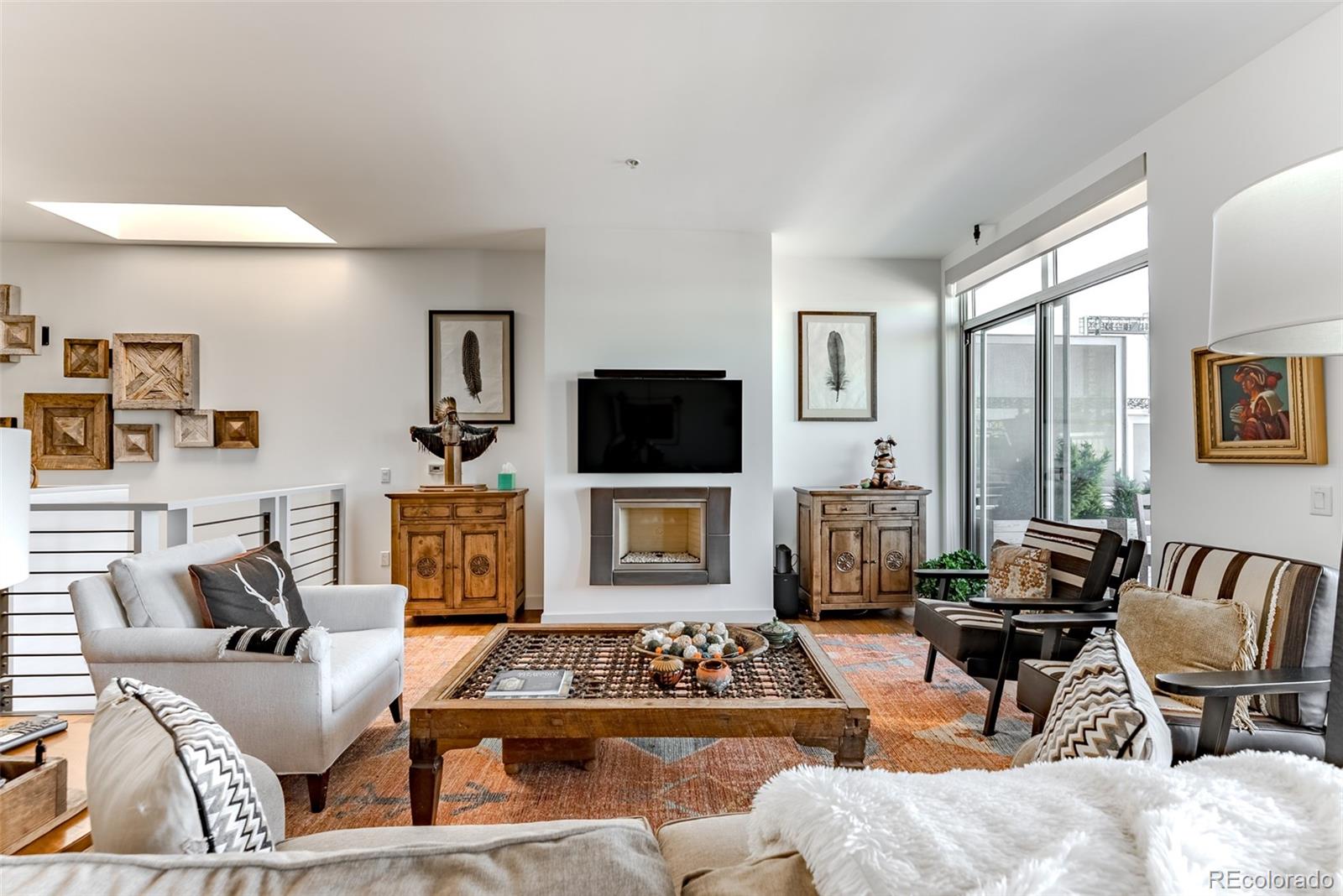 2229 Blake Street, Unit 709 Denver, CO 80205 - Photo 11 of 40 a living room with furniture a flat screen tv and a large window