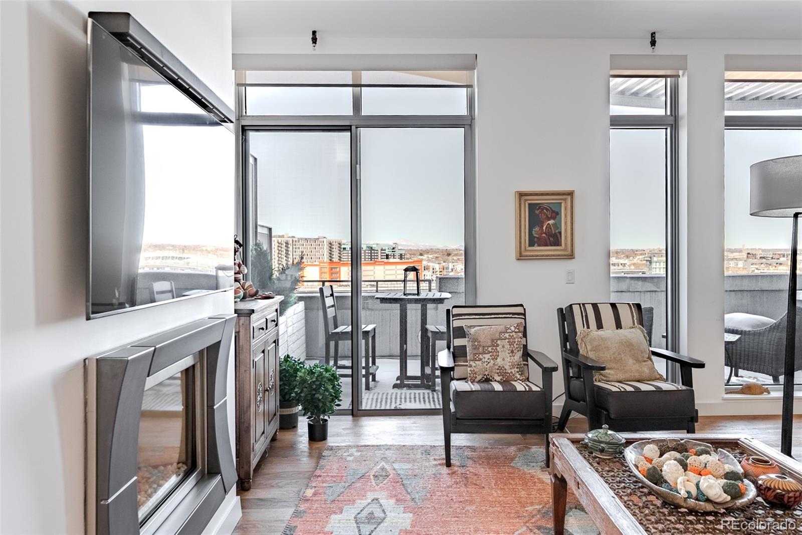 2229 Blake Street, Unit 709 Denver, CO 80205 - Photo 12 of 40 a living room with furniture large window and wooden floor