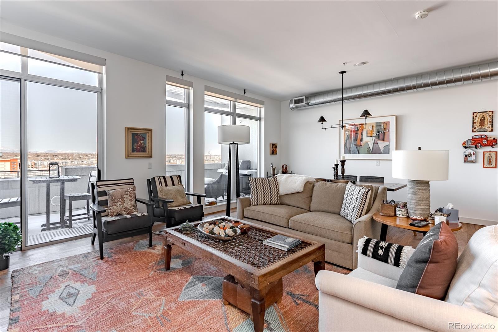 2229 Blake Street, Unit 709 Denver, CO 80205 - Photo 13 of 40 a living room with furniture potted plant and a large window