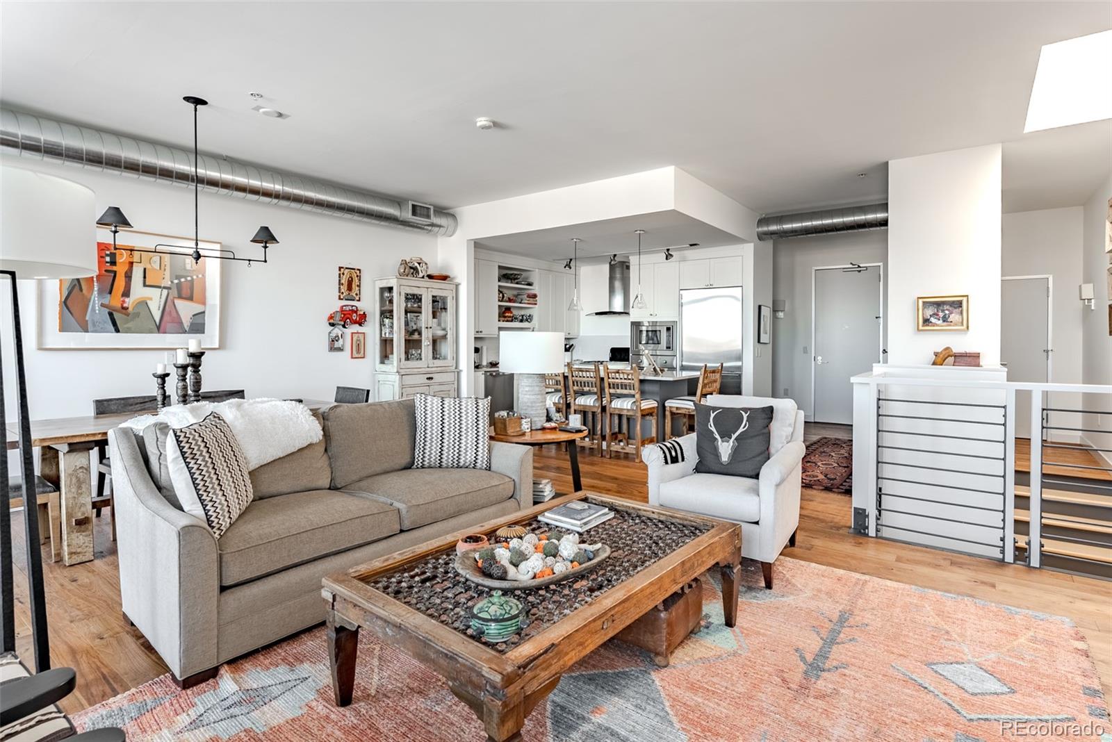 2229 Blake Street, Unit 709 Denver, CO 80205 - Photo 15 of 40 a living room with furniture a table and wooden floor