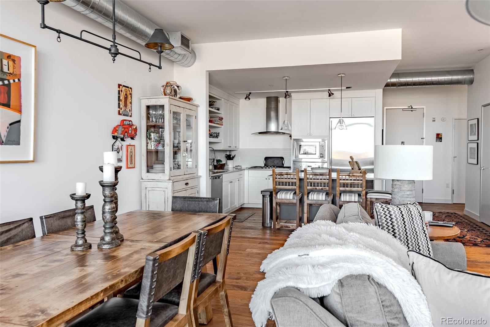 2229 Blake Street, Unit 709 Denver, CO 80205 - Photo 17 of 40 a living room with lots of furniture and kitchen view