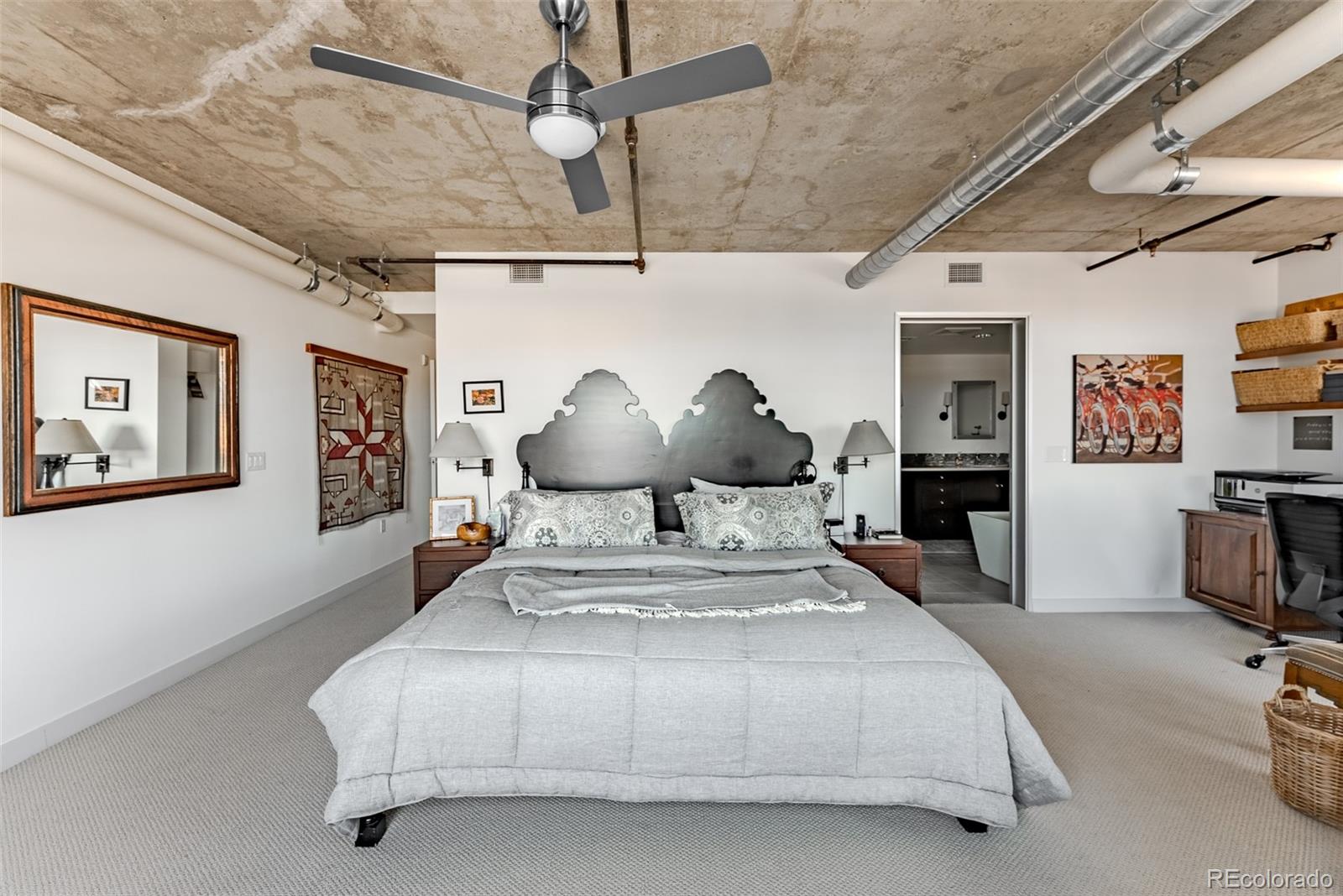 2229 Blake Street, Unit 709 Denver, CO 80205 - Photo 23 of 40 a bedroom with a large bed and a chandelier