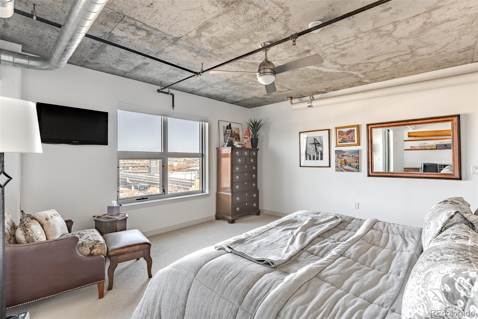 2229 Blake Street, Unit 709 Denver, CO 80205 - Photo 24 of 40 a bedroom with bed or couch and a window