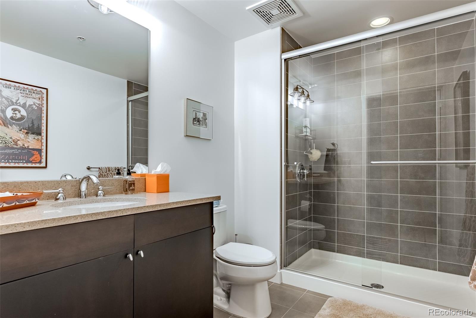 2229 Blake Street, Unit 709 Denver, CO 80205 - Photo 29 of 40 a bathroom with a sink toilet and shower