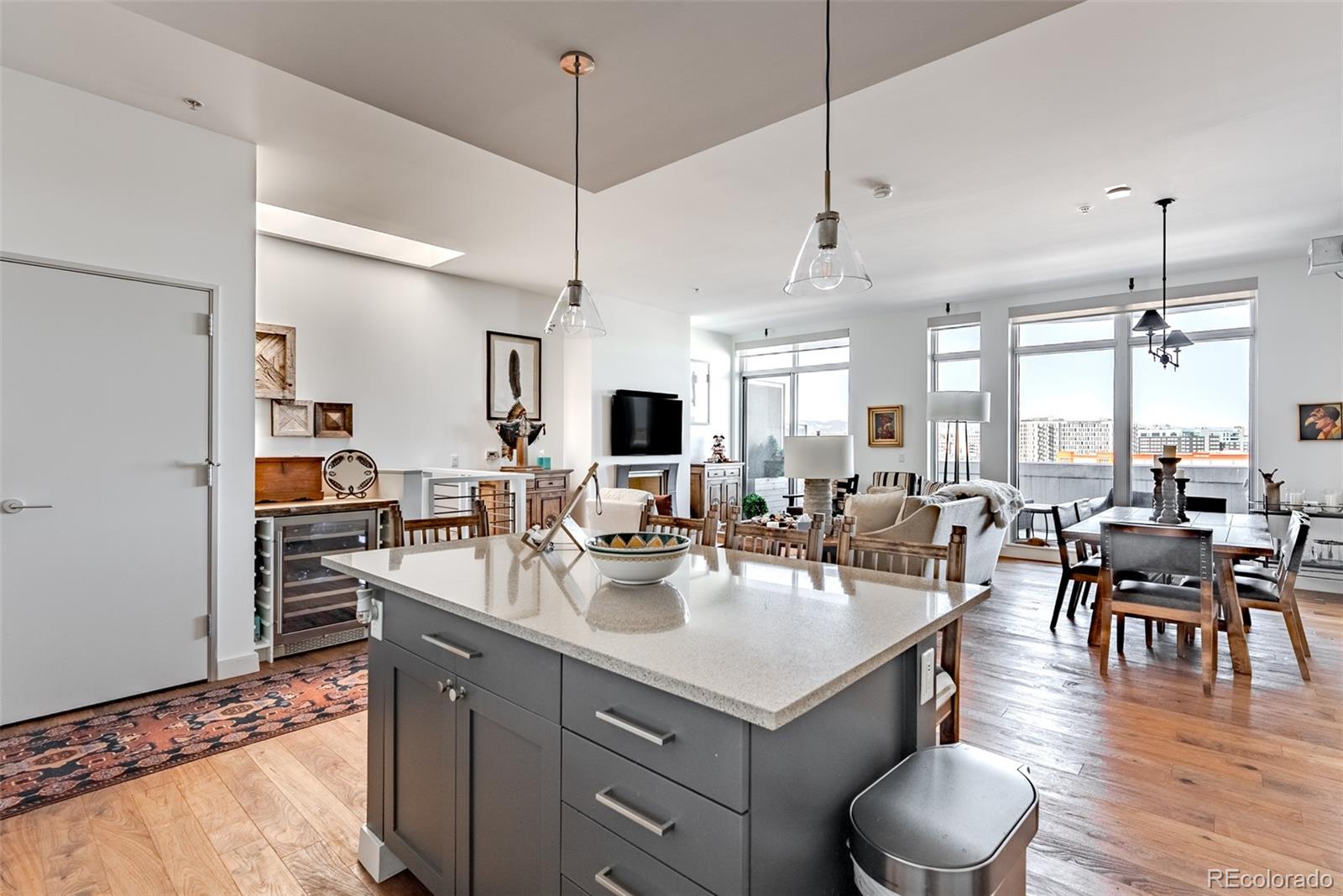 2229 Blake Street, Unit 709 Denver, CO 80205 - Photo 8 of 40 a kitchen with a dining table chairs stainless steel appliances and cabinets