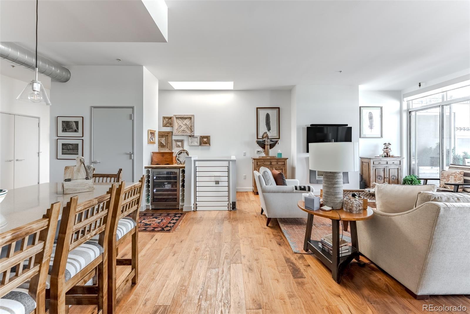 2229 Blake Street, Unit 709 Denver, CO 80205 - Photo 9 of 40 a living room with furniture and a wooden floor
