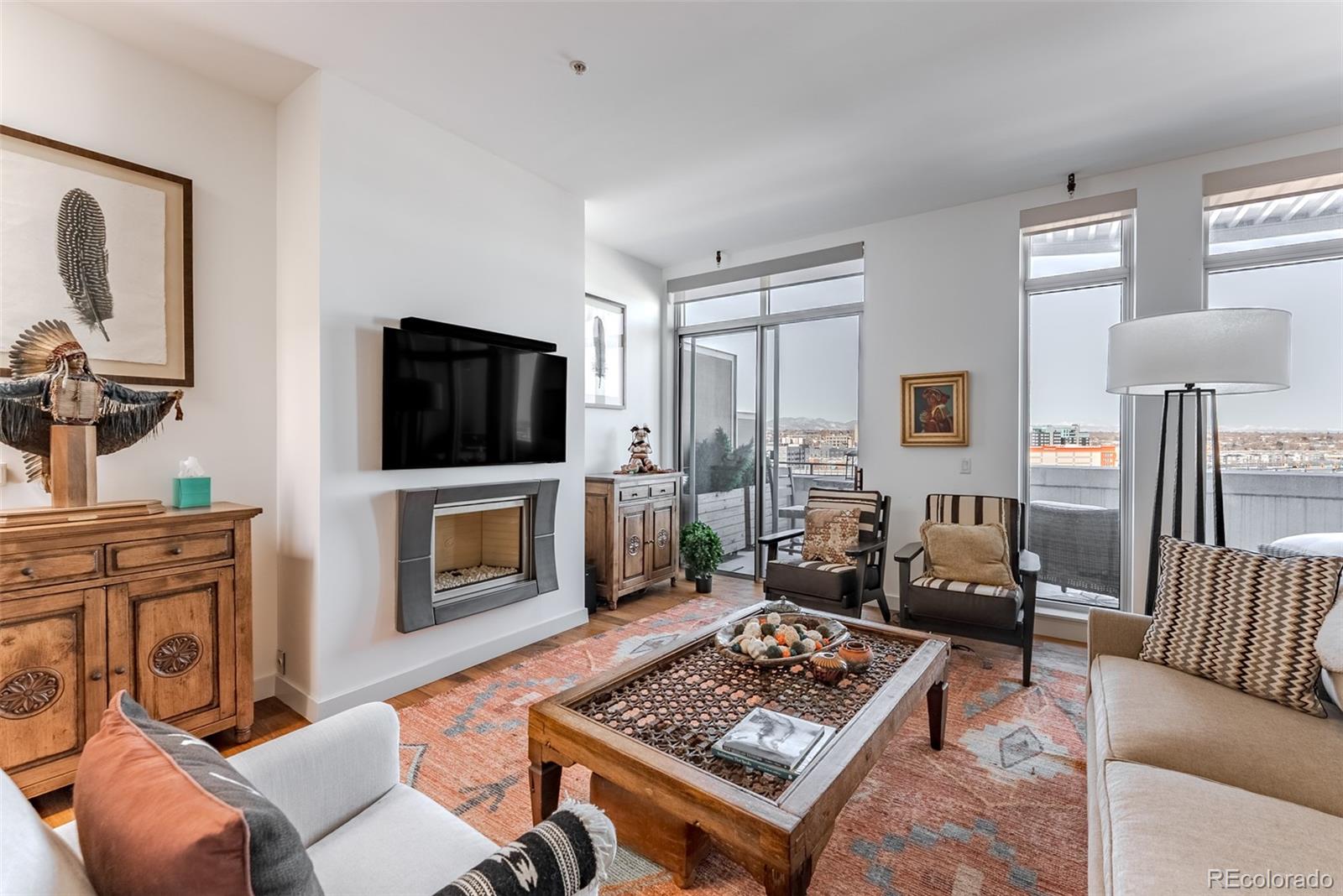 2229 Blake Street, Unit 709 Denver, CO 80205 - Photo 10 of 40 a living room with furniture and a fireplace