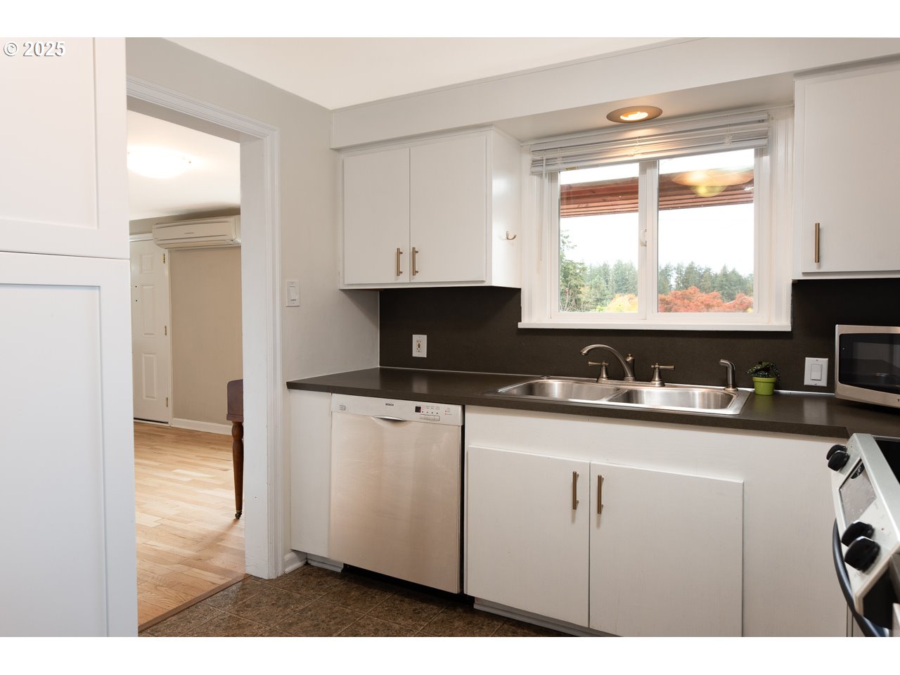 2575 Chula Vista Boulevard Eugene, OR 97403 - Photo 18 of 40 a kitchen with a sink a window and cabinets