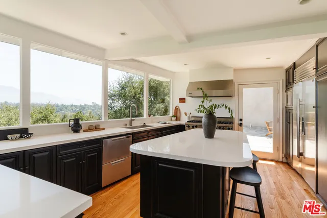 a kitchen with a sink a counter and a large window