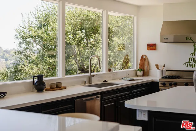 a kitchen with a stove a sink and a cabinets