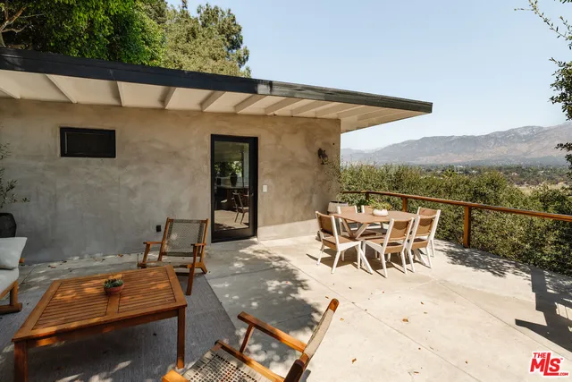 a bedroom with furniture and a large window