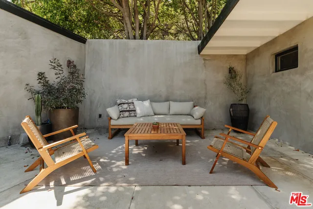 a bed room with a bed and large windows