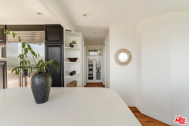 a view of a chair and fire pit in the backyard of a house