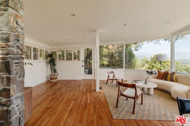 a living room with furniture and large windows