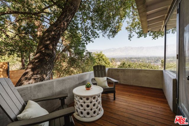 a view of a chairs and table in the balcony