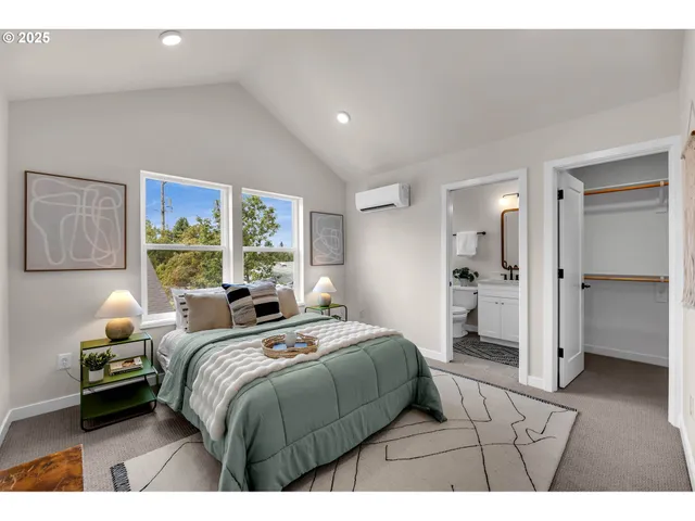 a bedroom with a bed and a large mirror