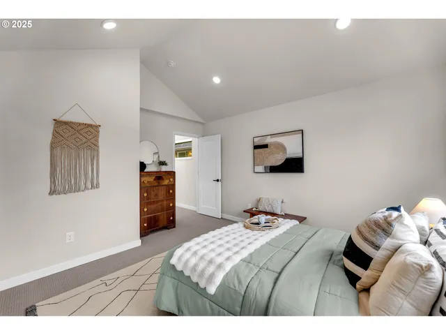 a bedroom with a bed and a television