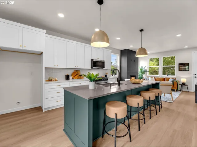 a kitchen with a dining table chairs sink and cabinets
