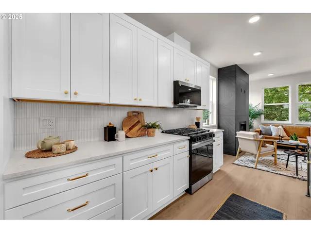 a kitchen with white cabinets and appliances