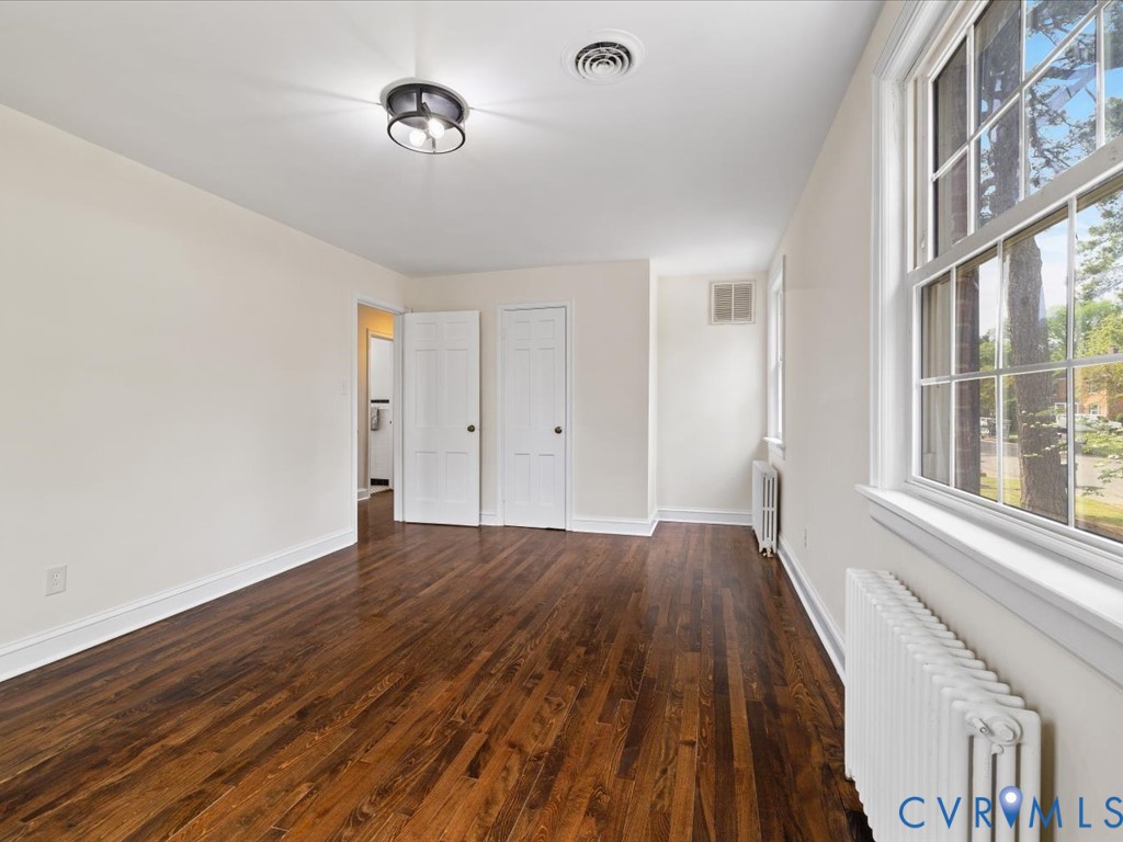 4803 Morrison Road Richmond, VA 23230 - Photo 34 of 45 a view of an empty room with wooden floor and a window