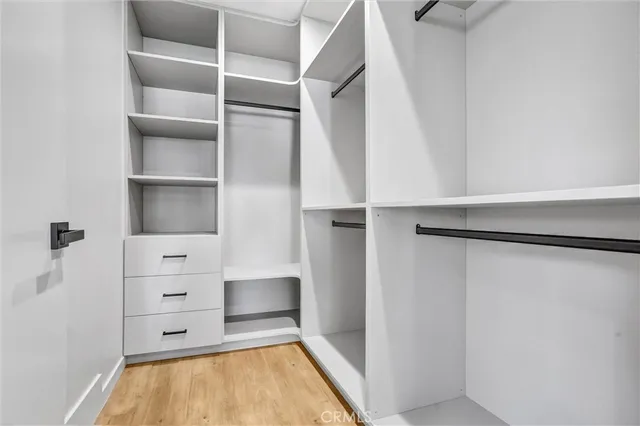 a view of walk in closet with empty racks