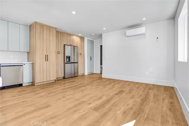a view of kitchen with stainless steel appliances granite countertop a refrigerator and a stove top oven