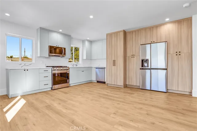 a view of an empty room with closet and a window